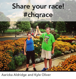 Aaricka Aldridge and Kyle Oliver holding hands in triumph infront of the capital building.